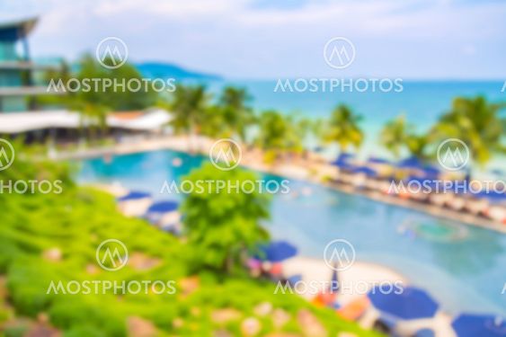 Abstract blur Swimming pool with relaxing seats near beach