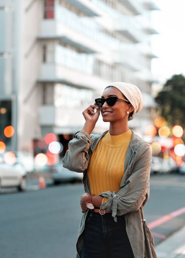 Happy woman, travel and sunglasses in city for tourism,...