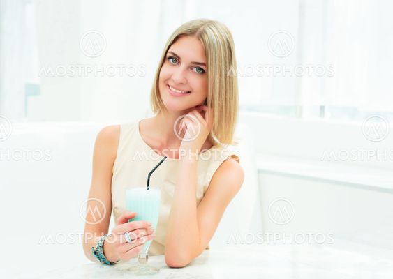 Portrait of a cute woman in a city cafe