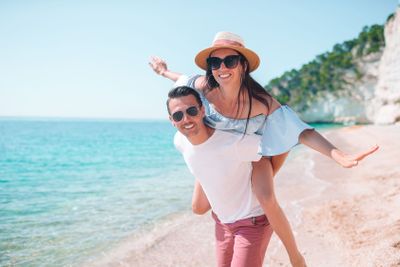 Young couple on white beach during summer vacation.