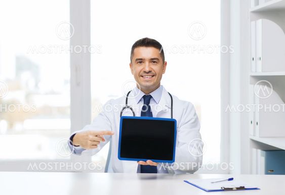 smiling male doctor showing tablet pc blank screen