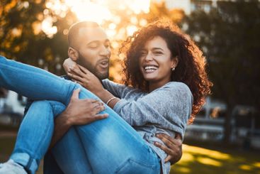 Carry, laughing and couple with fun at park for...