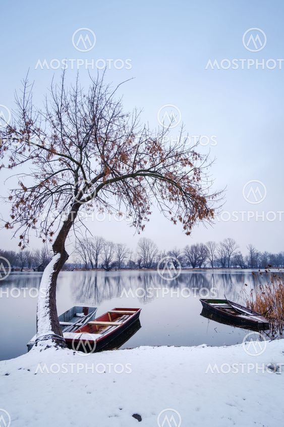 River boat on winter frozen river snow landscape