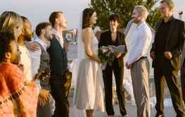 Smiling young couple looking at each other while exchanging vows at reception