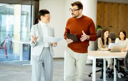 Engaging discussion between colleagues in a modern office...