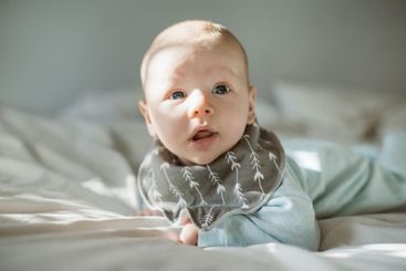 Adorable, innocent and baby boy on a bed resting,...