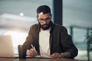 Businessman, writing and notebook in office at night for...