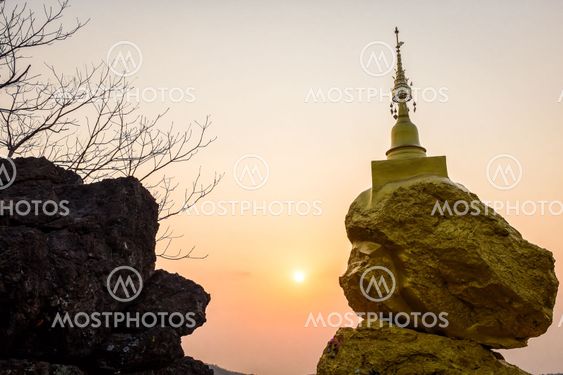 pagoda on rock stone and sunset time
