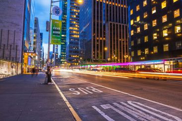 Light trails from cars moving along Fifth Avenue in evening