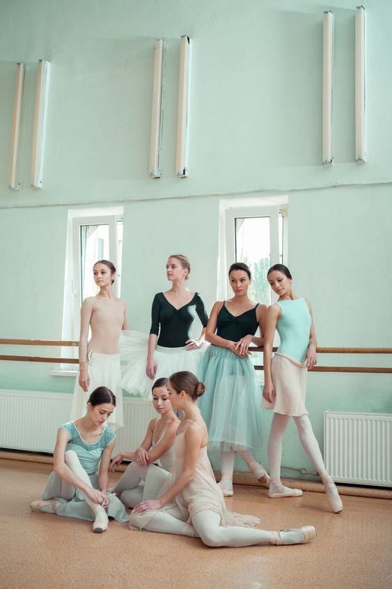 The seven ballerinas at ballet bar