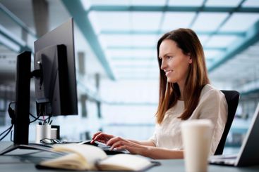 Young woman using laptop for online learning course in...