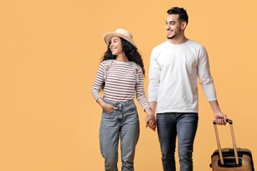 Travel Offer. Smiling Arab Couple Walking With Suitcase...