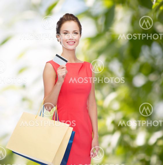 smiling woman with shopping bags and plastic card