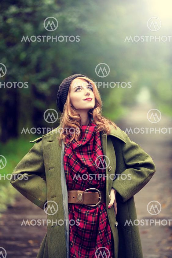 Style redhead girl at beautiful autumn alley.