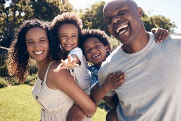 Happy, backyard and portrait of parents with children in...