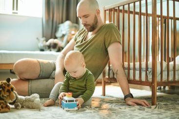 Learning, playing and development, man and baby on...