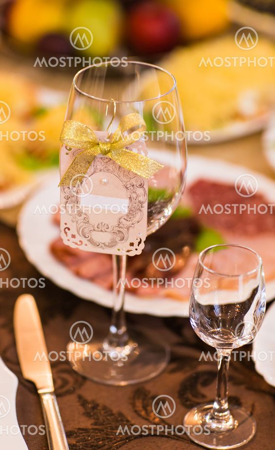 Close-up of wine glass and name card on festive table