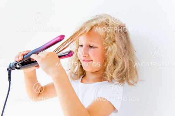 Girl dries and styles her hair