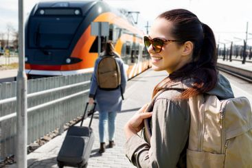 woman with backpack traveling by train in estonia