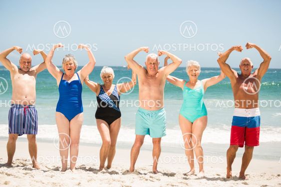 Seniors posing with muscles at the beach