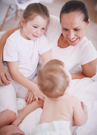 Children, mother and relax together in home, love and...