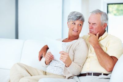 Couple calculating domestic bills. Loving mature couple...