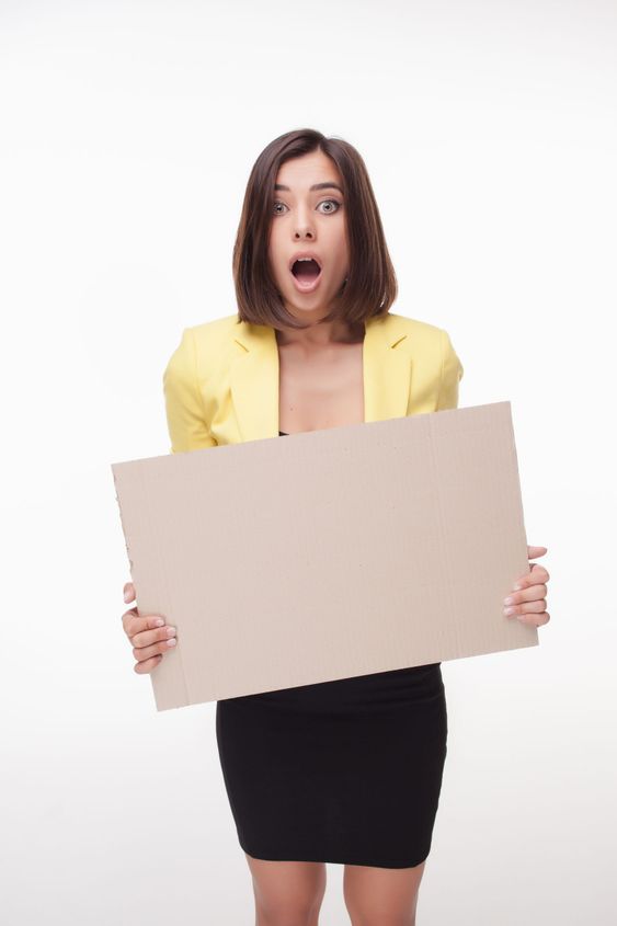 Businesswoman showing board or banner with copy space on...