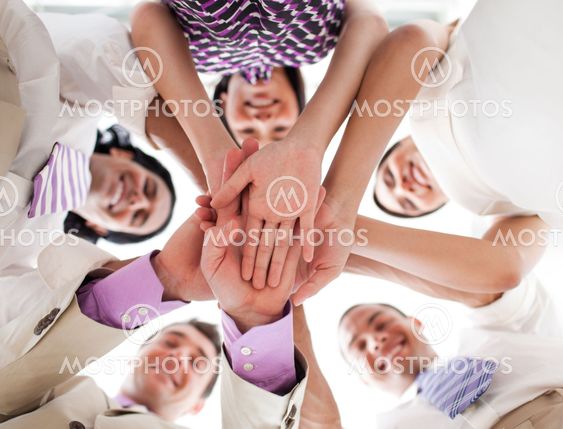 Business people holding hands together