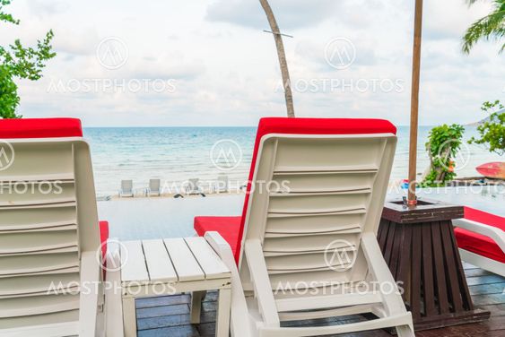 Beautiful beach chairs with umbrella around outdoor...