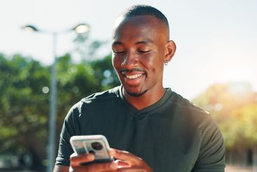 Outdoor, black man and fitness with phone for social...