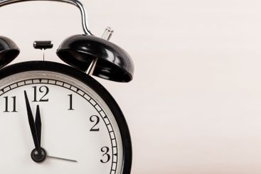 Close up of a black old-fashioned alarm clock