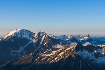 mountain peaks in morning light, panoramic natural...
