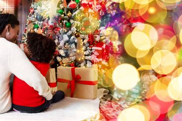 Loving mom cuddling her daughter while sitting together...