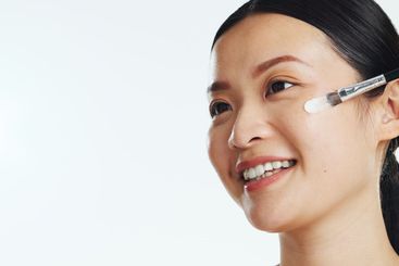 Asian woman, face and brush cream for beauty, aesthetic...