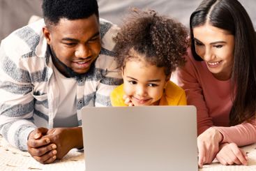 Multiracial family looking at laptop during quarantine