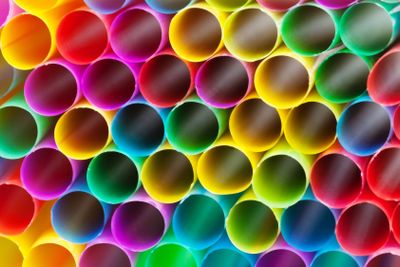 multicoloured plastic drinking straws close up