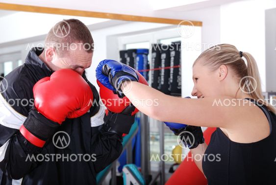 .woman and man box fighting