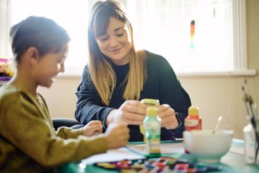 Education, paint or art with a mother and son in a...