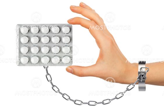 Chained hand with pills