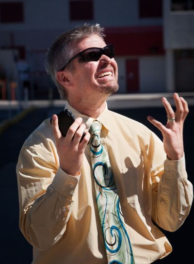 Man screams in dispair over cell phone.