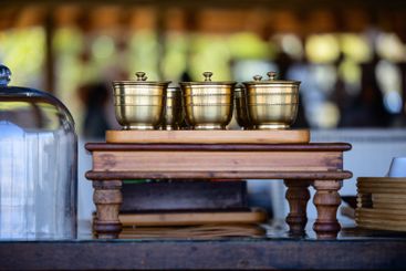 Brass containers on wooden stand.