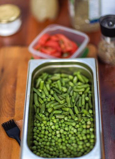 Cooking a healthy vegetarian dish. A metal bowl with...