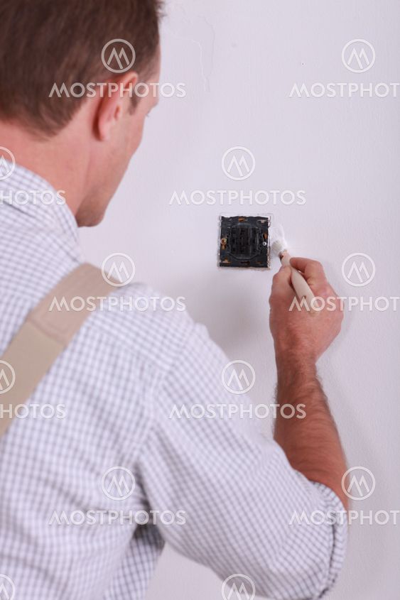 painter retouching wall