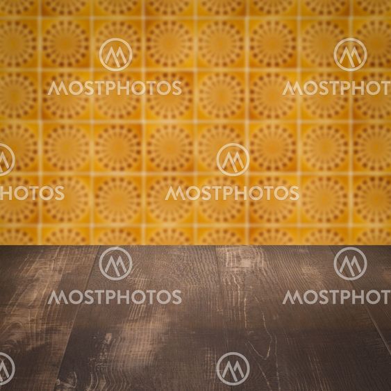 Wood table top and blur vintage ceramic tile pattern wall