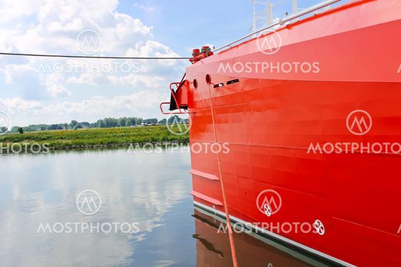 Bow of new red ship at the port