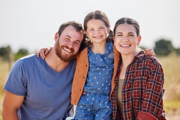 Portrait, parents and child with hug in farm,...