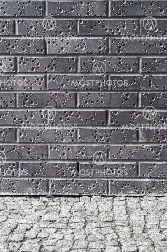 Dark brick wall and grey pebble floor