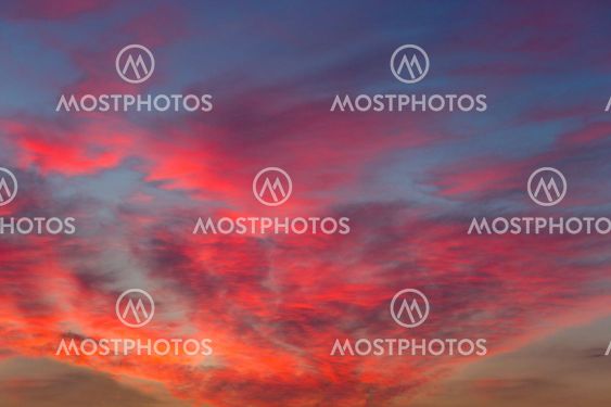 Pink purple sunset clouds on a blue sky. Colorfull...