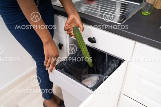 African Woman Throwing Away Food