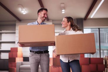 Happy Young Couple Moving Boxes